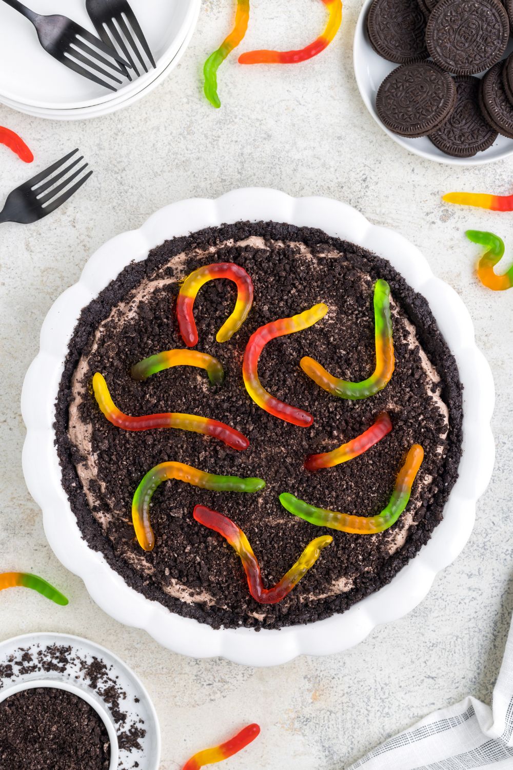 gummy worm topped dirt pie on table