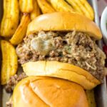 Slow Cooker French Dip Sandwiches on tray with fries behind it
