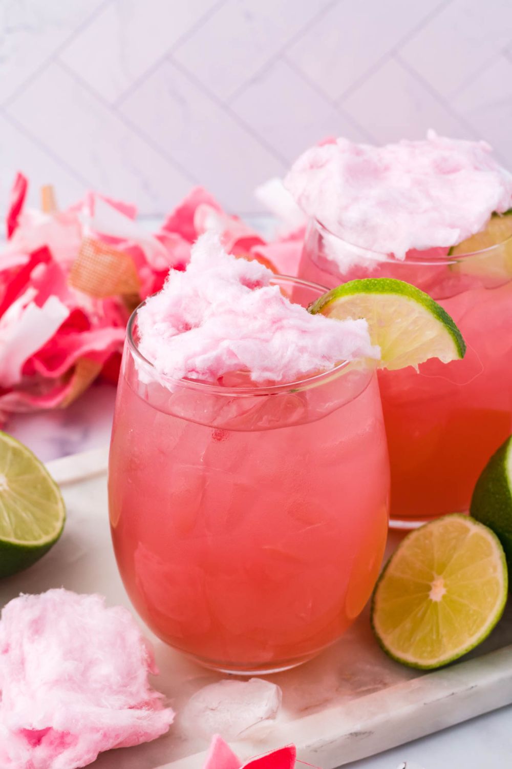 candy margaritas on table with lime wedges on table