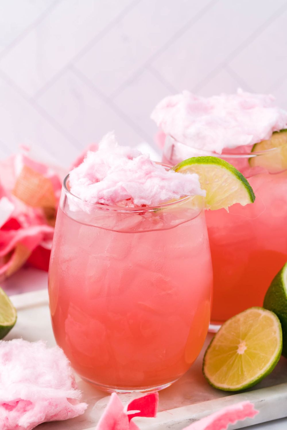 cocktail with cotton candy on top and decorations around it for staging