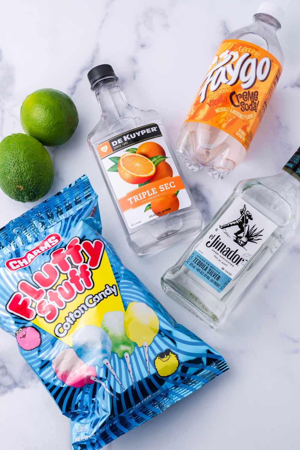 ingredients for a cotton candy margarita on table