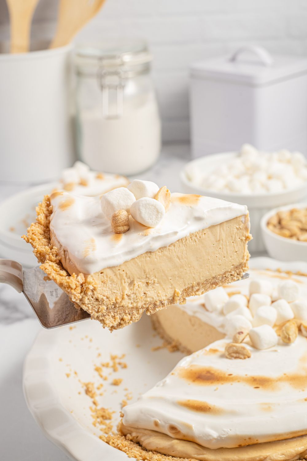 peanut butter pie with cream cheese on a slice on spatula