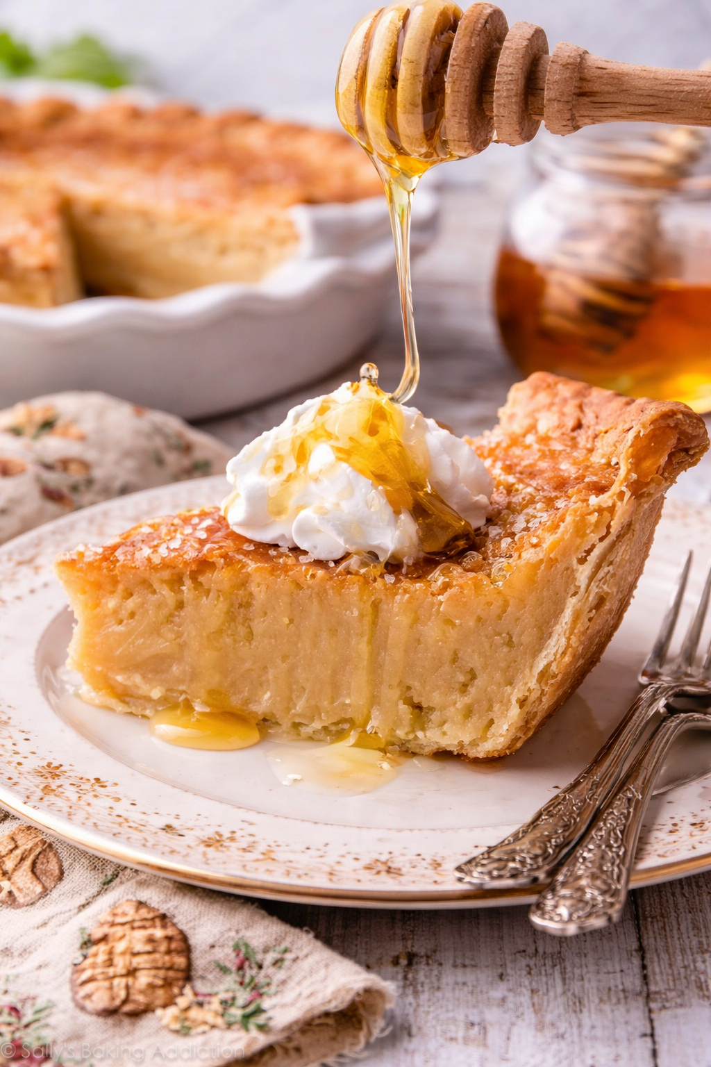 Honey Pie on a pretty white plate with honey being drizzled on top 