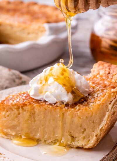 Honey Pie on a pretty white plate with honey being drizzled on top