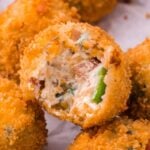 Jalapeno Popper Bite with a bite taken out sitting on table