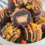Reese's Oreo Balls in a bowl with one cut in half
