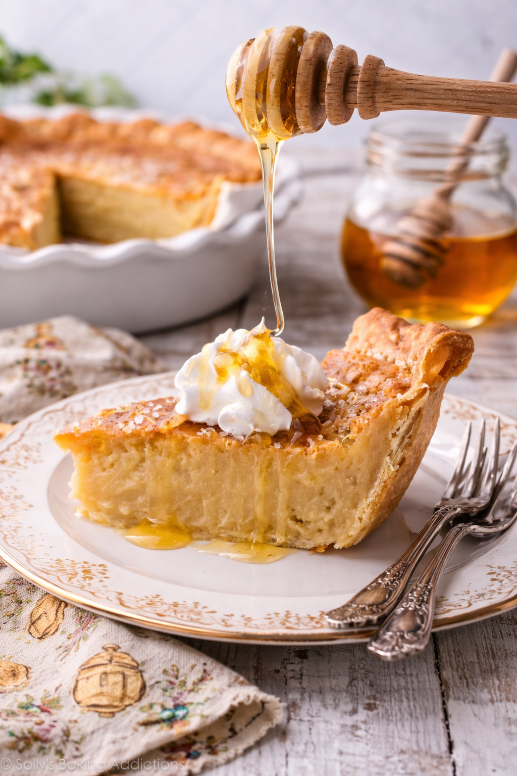 Honey Pie on a pretty white plate with honey being drizzled on top 