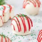 Little Debbie Christmas Tree Cake Truffles On table with a christmas tree cake behind it