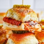 Pastrami Sliders stacked on table with toothpick in the center