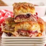 Thanksgiving Sliders stacked on plates on table