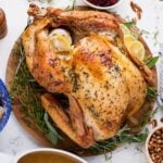 whole roasted turkey on a platter on table