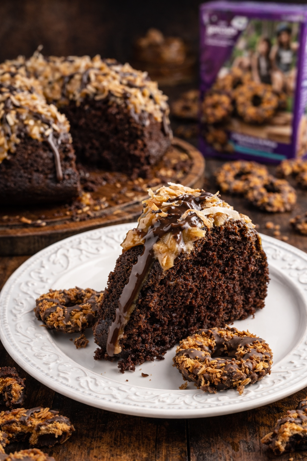 Samoa Cake slice on a pretty white plate on a dark table 