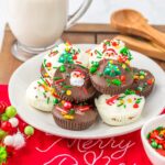 Christmas Peanut Butter Cups on a plate with a glass of milk in the background