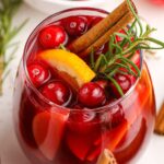 Cranberry Apple Christmas Sangria in a glass with garnishes