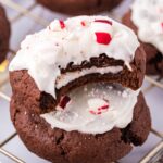 Stuffed Peppermint Patty Cookies stacked on table with a bite taken out of top cookie