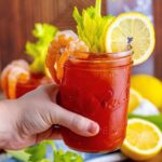 Bloody Mary in hand above table