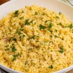 Souper Rice in a white bowl with some parsley garnished on top