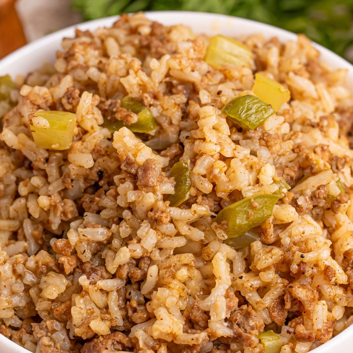 Dirty Rice in a white bowl sitting on a table
