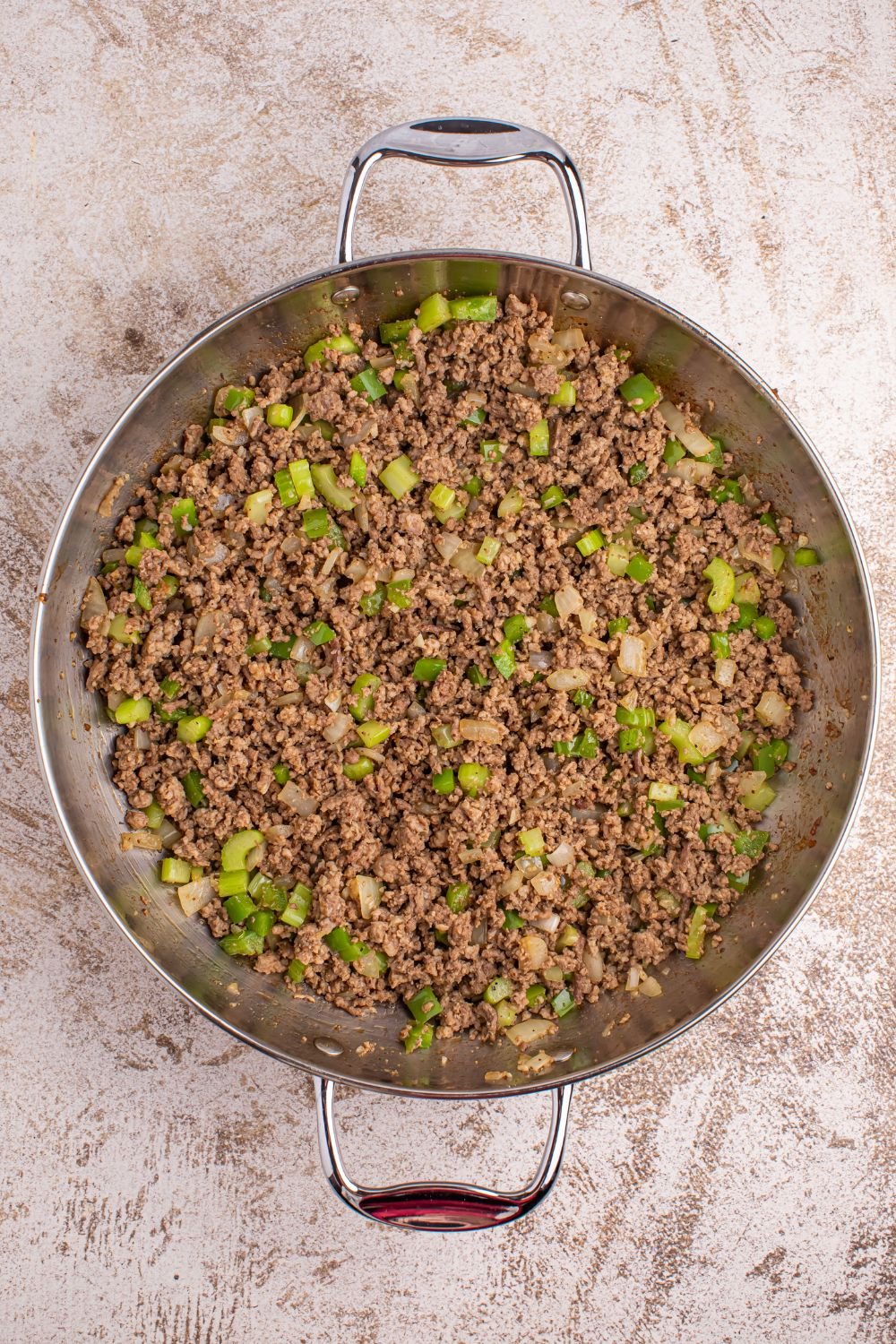 Dirty Rice - ground meat and vegetables in pan on table 