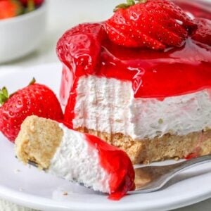 No Bake Strawberry Delight on plate with a fork with a bite taken out of it