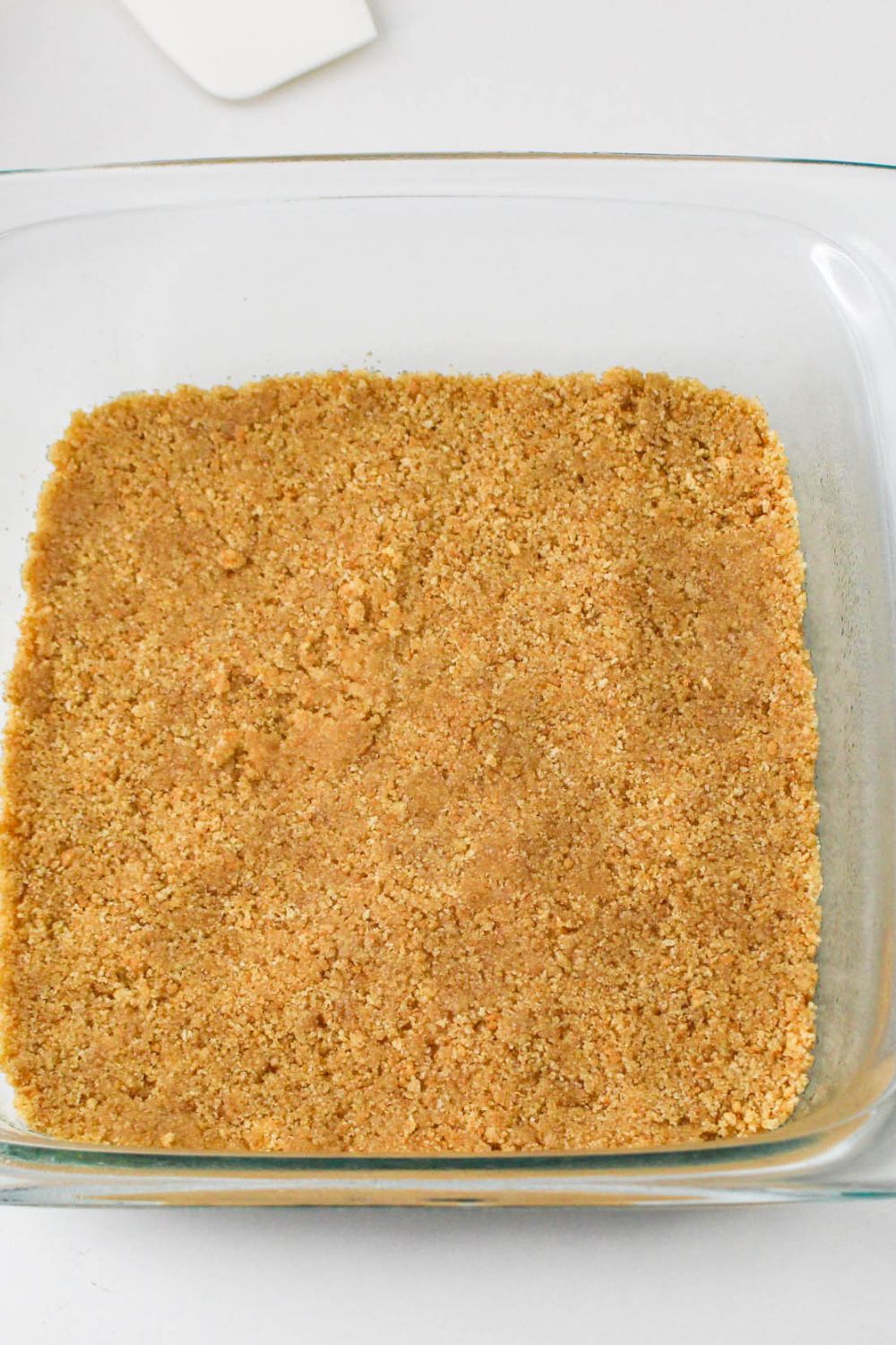 graham cracker crust pressed into pan for the No Bake Strawberry Delight