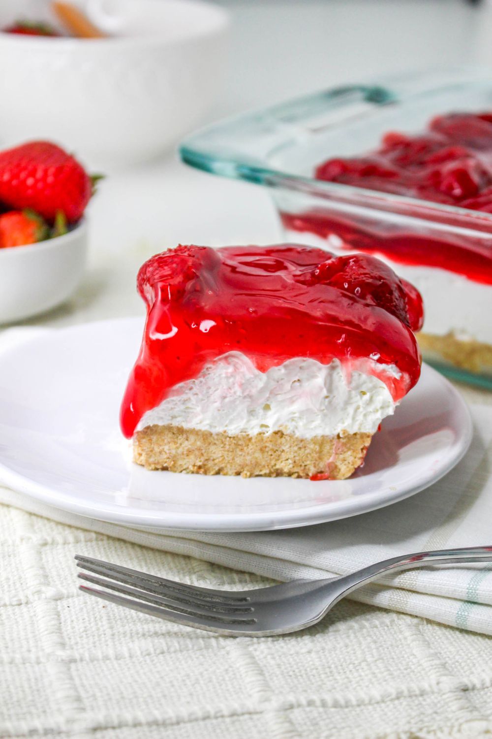 No Bake Strawberry Delight on plate with a fork on table 