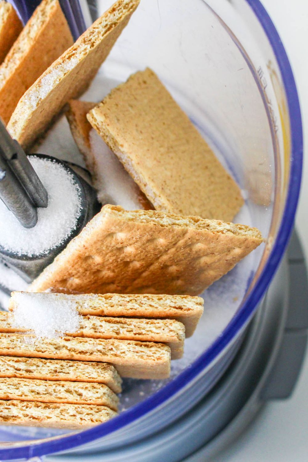 food processor with crackers and sugar in it for making the No Bake Strawberry Delight