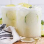 Brazilian Limeades in glasses on table with a towel around it