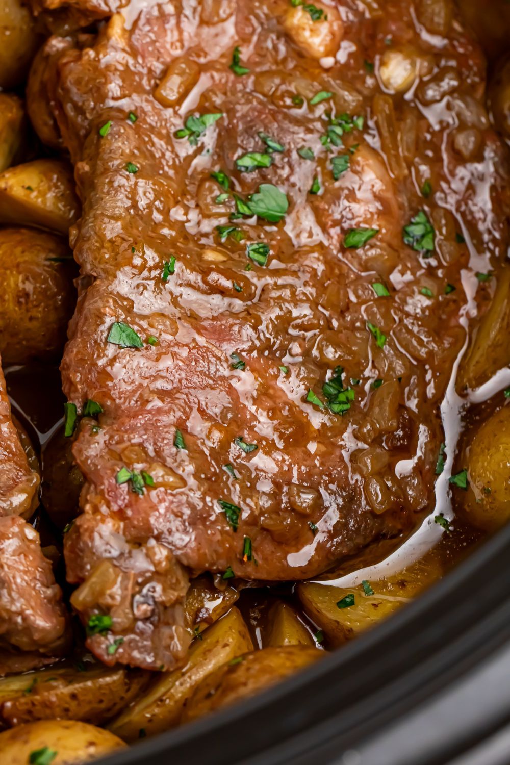 Crock Pot Steak and Potatoes sitting in a crock pot 