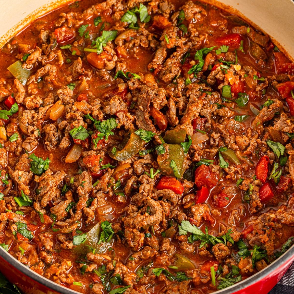 Carne Picada in a Dutch oven showcases all the simmered beef and vegetables 