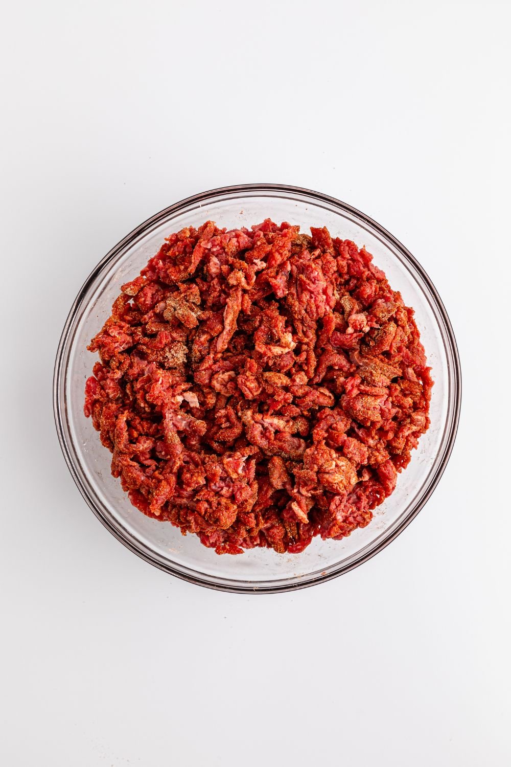 seasoned chopped beef in a glass bowl 