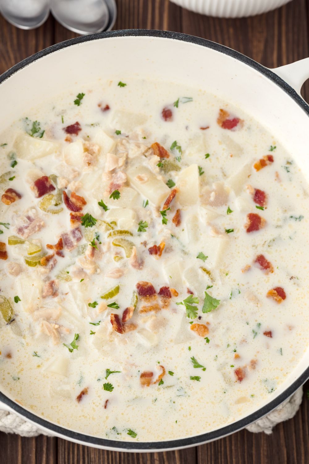 New England Clam Chowder in a large Dutch Oven sitting on table 
