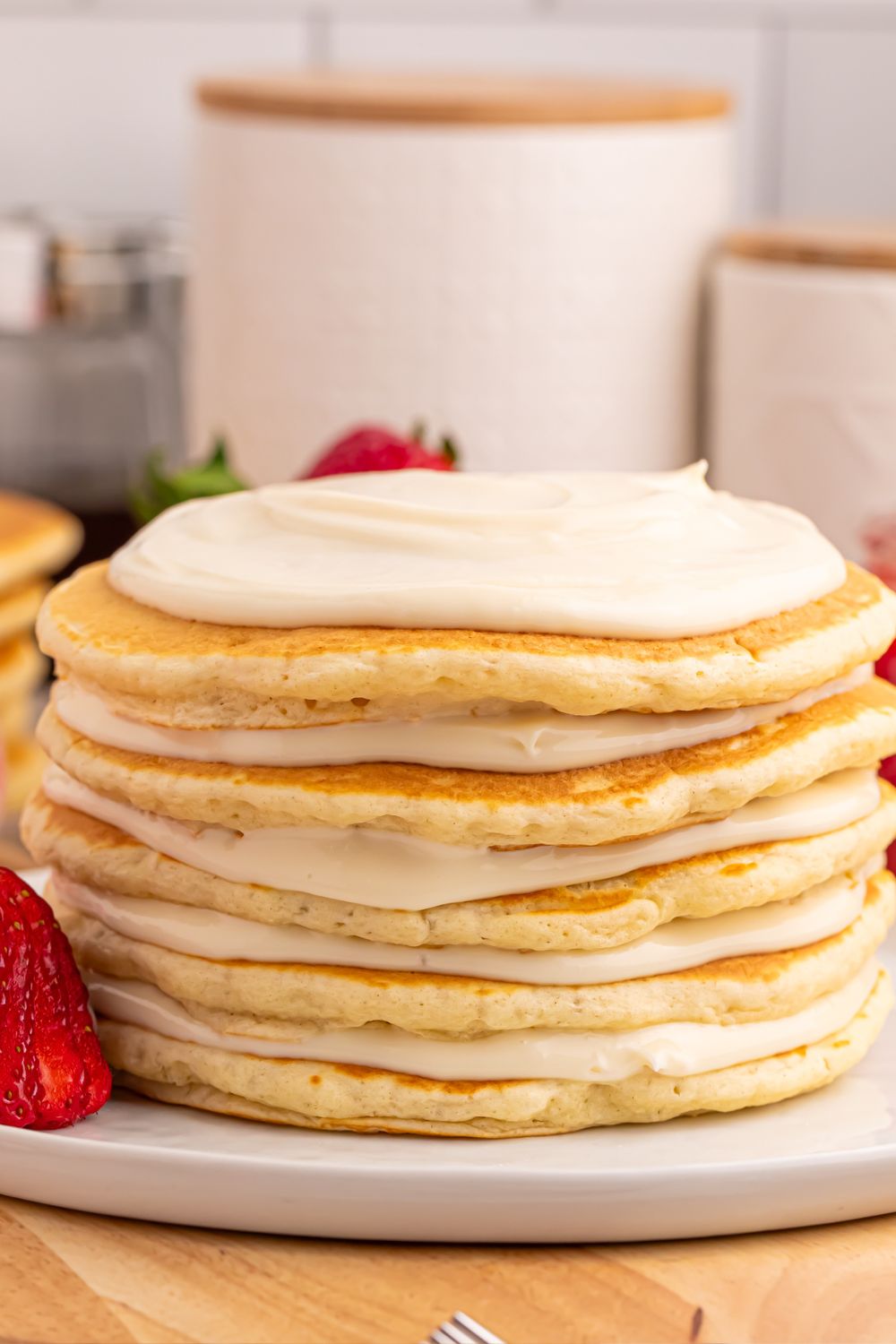 pancakes with cream cheese cheesecake spread on top of each pancake 