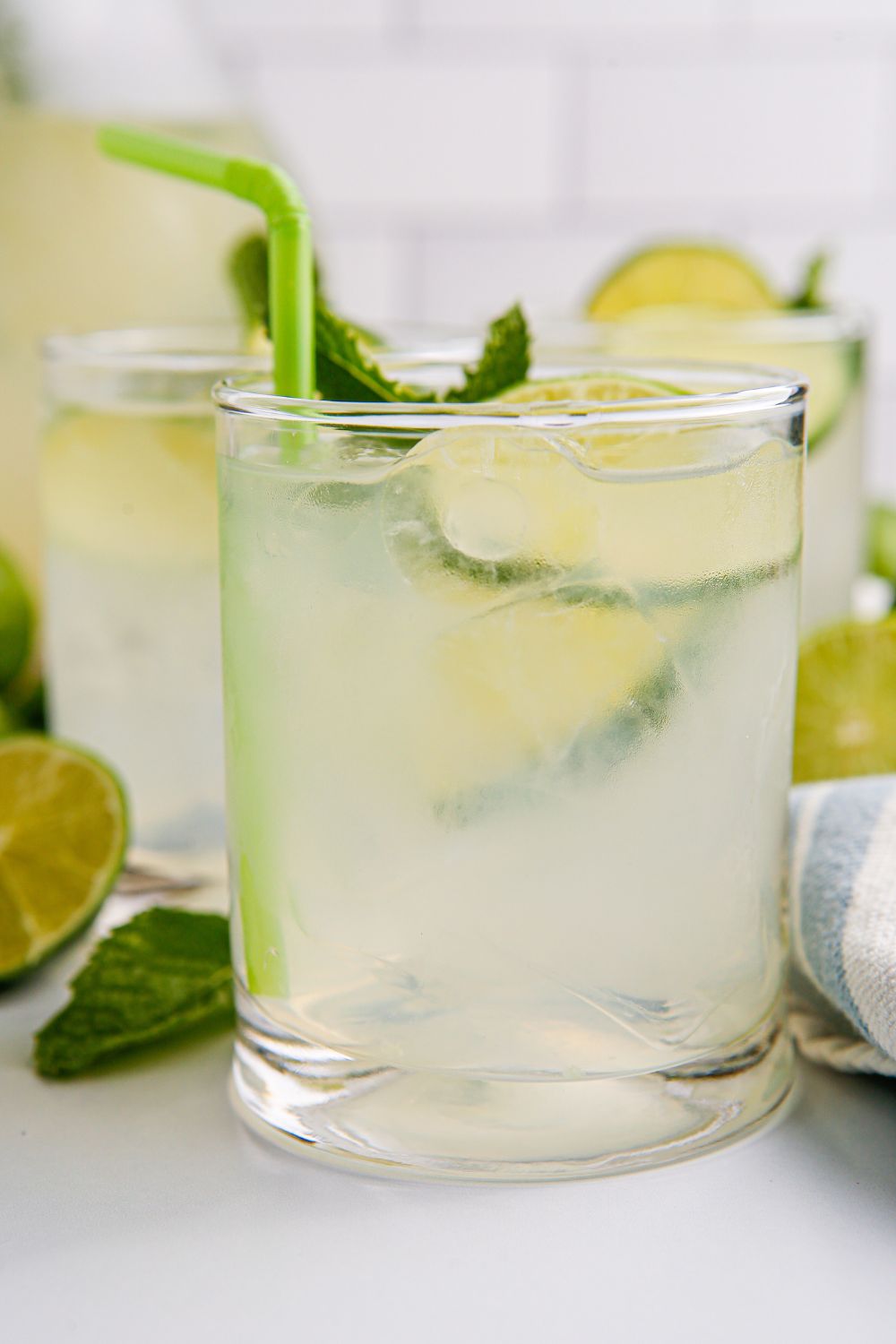 Limeades in glasses with ice, limes, and mints 