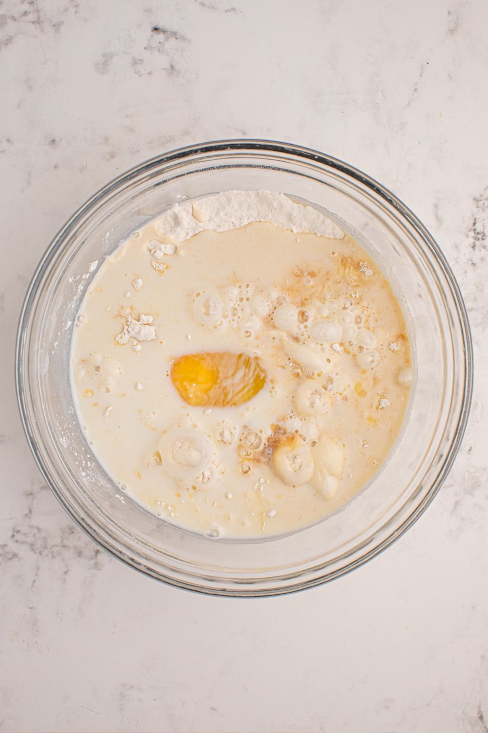 pancake mixture in a glass bowl on table 