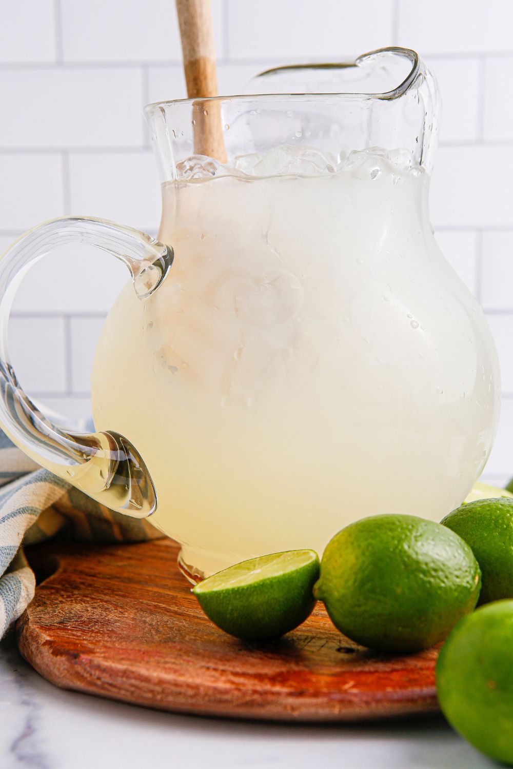 pitcher with limeade in it and a wooden spoon in pitcher 