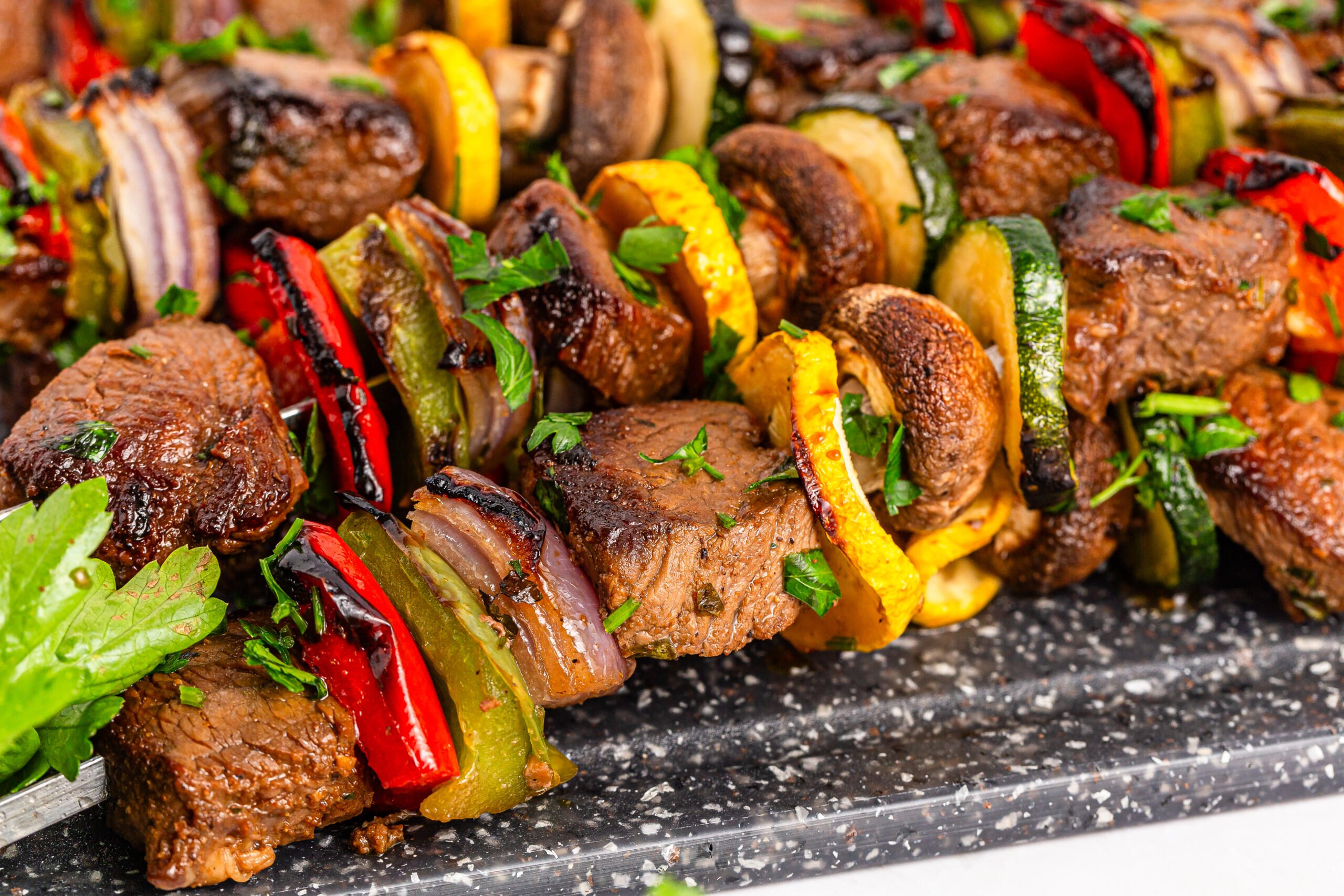 up close shot of my Marinated Beef Kabobs stacked on top of each other on a tray 