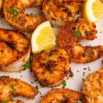 Cajun Grilled Shrimp on table with lemon slices on table