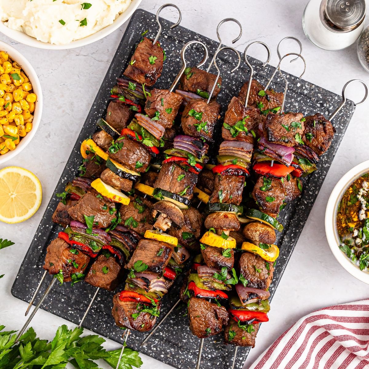 Marinated Beef Kabobs on a platter sitting on table