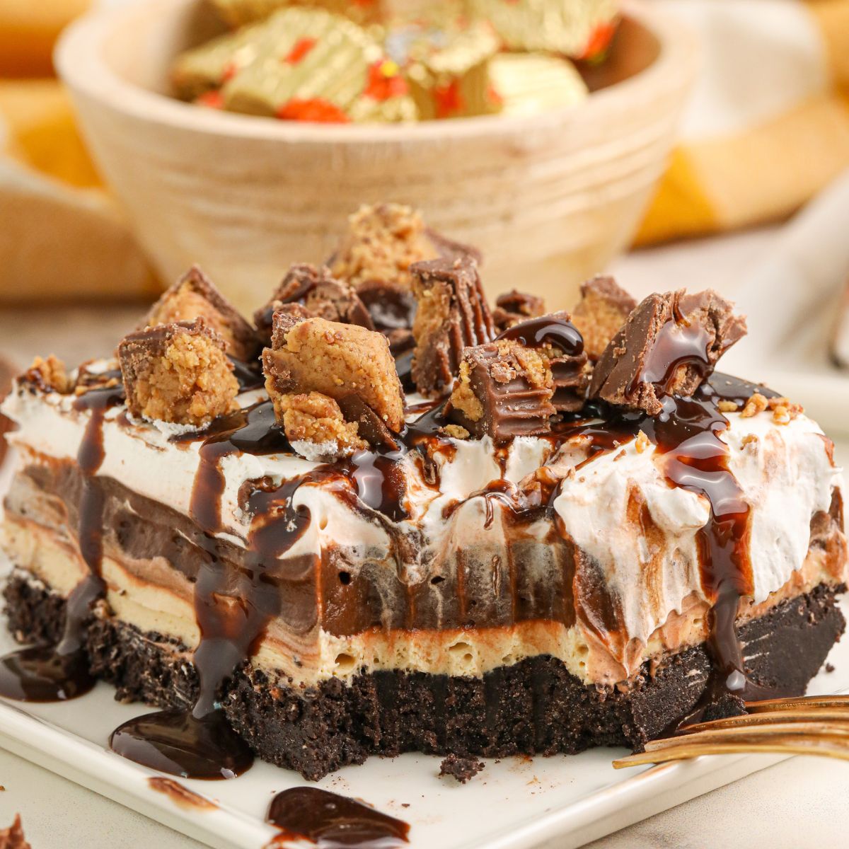 Reeses Lasagna on a plate with one bite taken out of it 