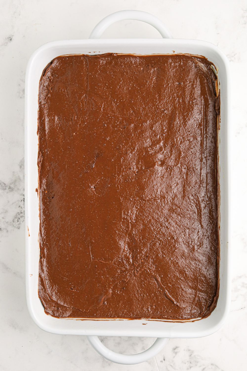 chocolate pudding spread over a 9x13 pan for Reese's Lasagna 