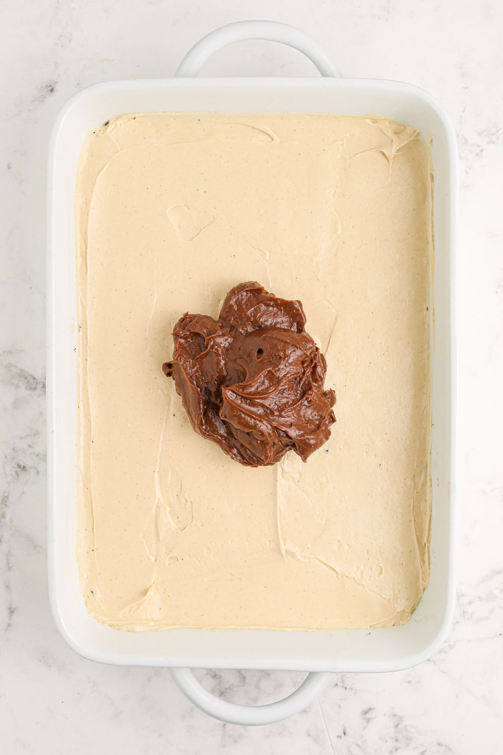 Reeses Lasagna with peanut butter cream cheese layer spread evenly then chocolate pudding in center 