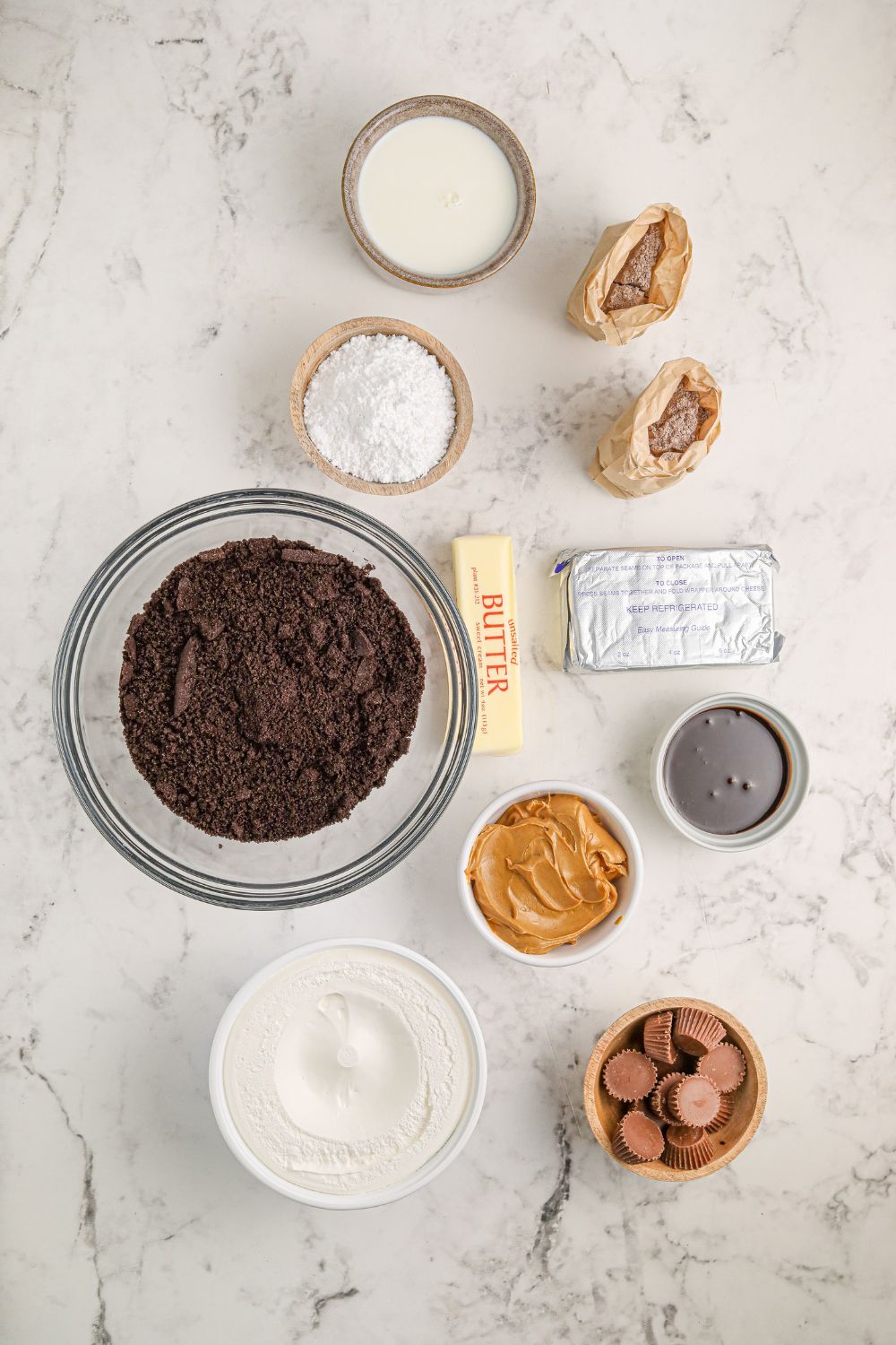 ingredients for no bake reeses lasagna on table in single serve bowls