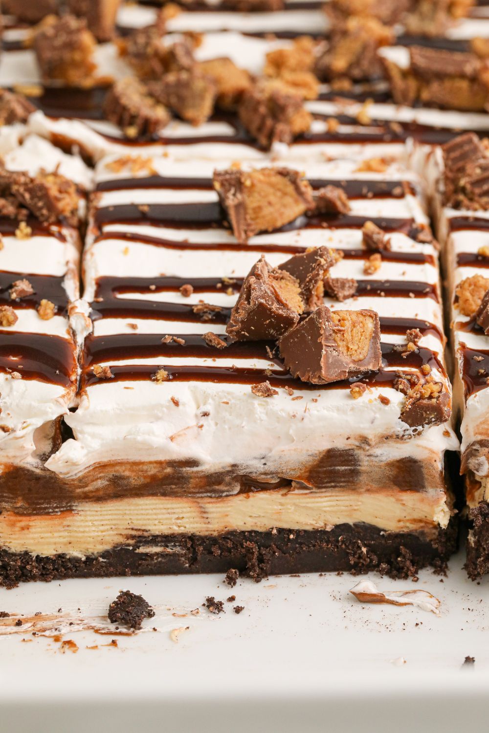 Reeses Lasagna in a white casserole pan with a few slices taken out of pan 