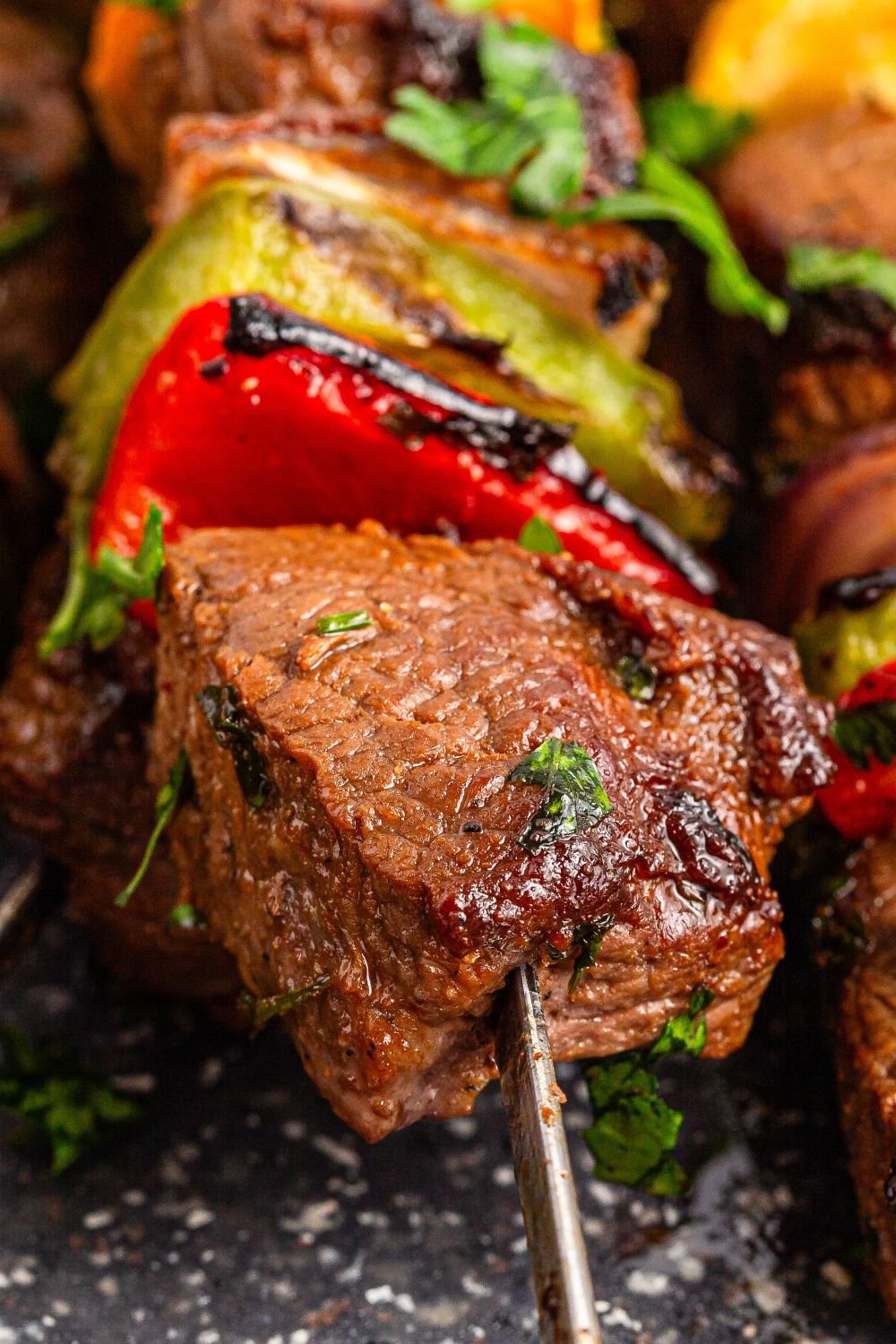 Marinated Beef Kabobs on tray showing a close up on grilled meat and vegetables 