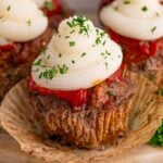 Meatloaf Cupcakes on table with the cupcake liner removed from the meatloaf