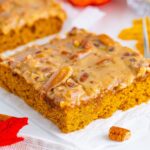 slice of Pumpkin Snack Cake with Praline Icing sitting on a napkin on table