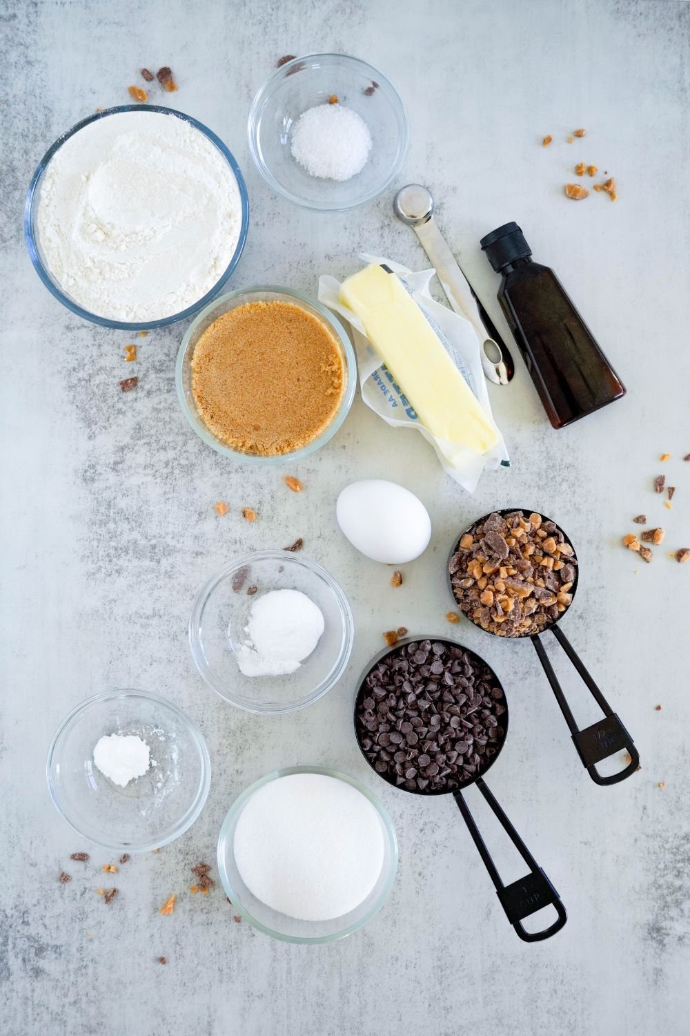 ingredients for Chocolate Chip Toffee Cookies on counter with ingredients in single serve containers 