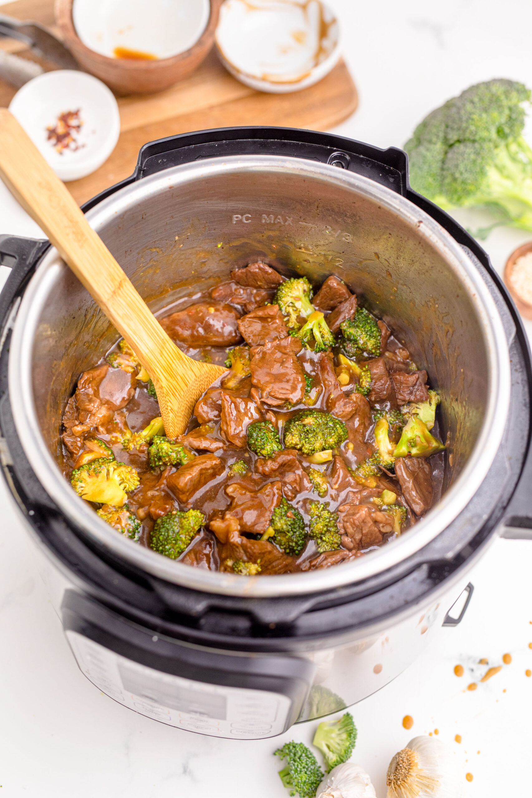 Instantpot Beef & Broccoli in the instantpot showing how delicious with a wooden spoon in the pot 