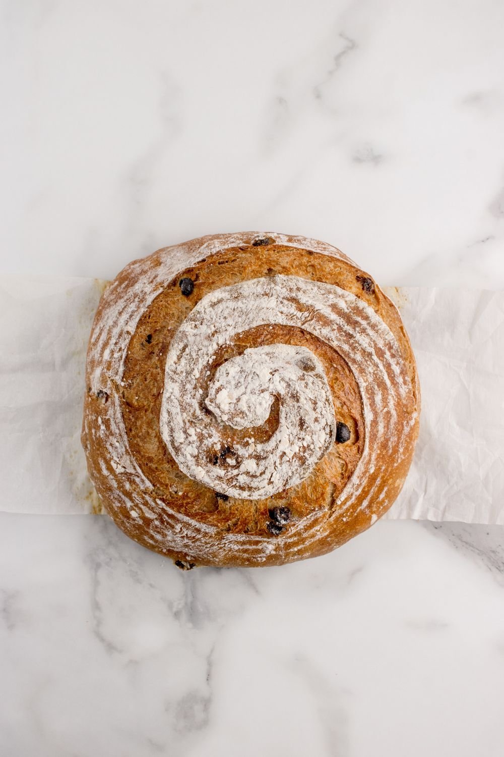 cinnamon raisin bread sitting on a marble countertop
